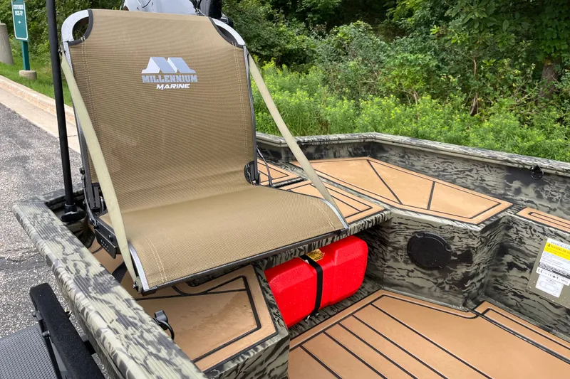 Slide: The Image of 2026 Tracker Grizzly 1650 T Prairie Wings Edition boat with Millennium Marine seat, camo design. - 16