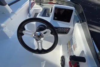 Slide: The Image of 2026 Tahoe T16 boat dashboard with steering wheel and control panel. - 65