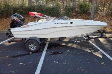 Slide: The Image of 2026 Tahoe T16 boat on trailer in wooded parking area. - 66