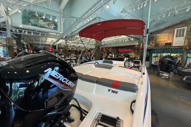 Slide: The Image of 2026 Tahoe T16 boat with Mercury engine displayed in a showroom. - 69