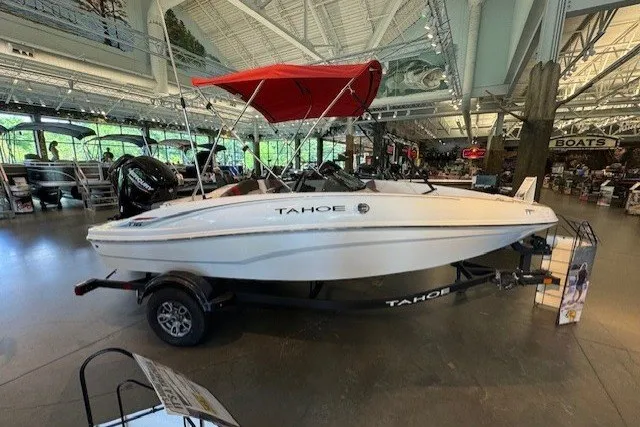 The Image of 2026 Tahoe T16 boat with red canopy displayed in a showroom. - 0