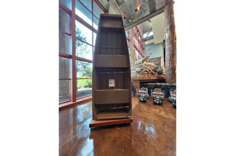 The Image of 2026 Tracker Grizzly 12 Jon boat displayed indoors with natural lighting and wildlife decor. - 0