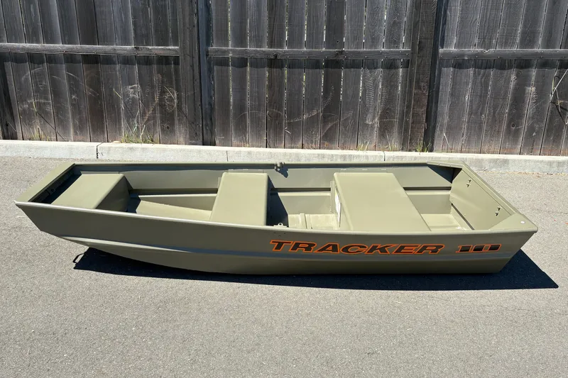 The Image of 2026 Tracker Grizzly 10 Jon boat on pavement, featuring a sleek, compact design. - 0