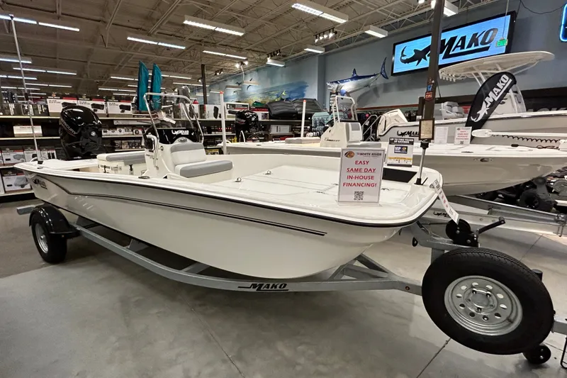 The Image of 2026 Mako Pro Skiff 17 CC boat displayed in showroom with financing sign. - 0