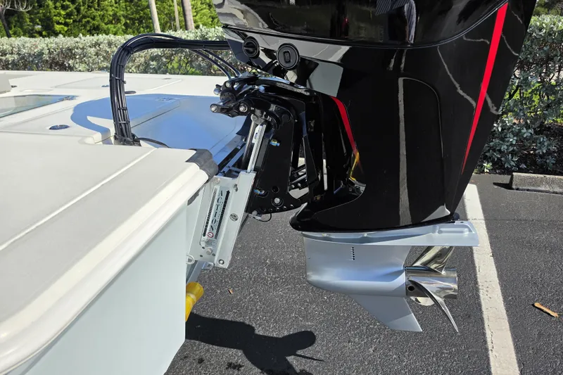 Slide: The Image of 2026 Mako 18 Pro Skiff boat motor and propeller detail in parking lot. - 15