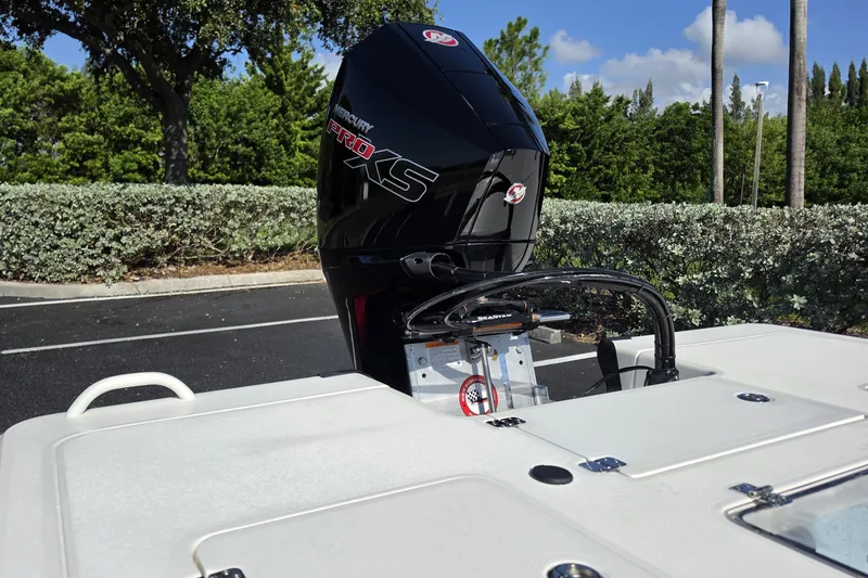 Slide: The Image of 2026 Mako 18 Pro Skiff with Mercury Pro XS engine in a scenic outdoor setting. - 13