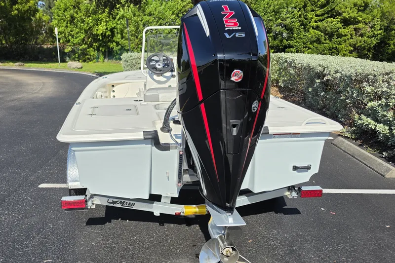 Slide: The Image of 2026 Mako 18 Pro Skiff with powerful 175 V6 engine, parked outdoors. - 14
