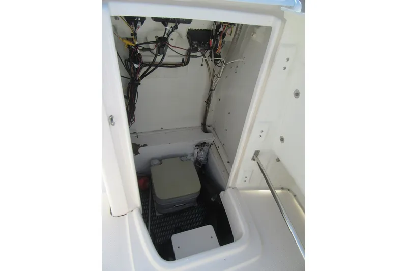 Slide: The Image of 2015 Robalo R180 Center Console interior wiring and storage compartment. - 14