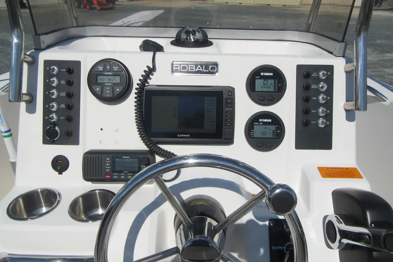 Slide: The Image of 2015 Robalo R180 Center Console dashboard with Garmin display and Yamaha gauges. - 16