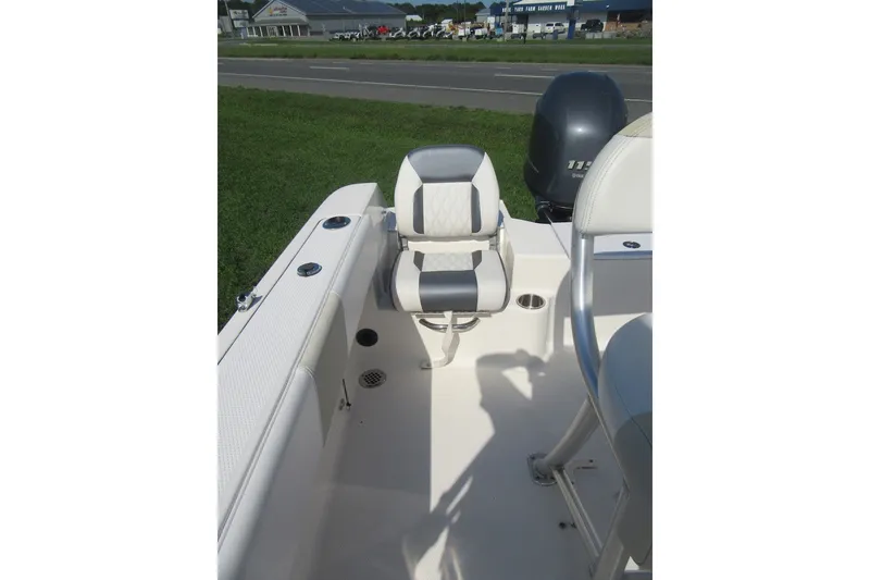 Slide: The Image of 2015 Robalo R180 Center Console boat interior with seating and motor. - 18