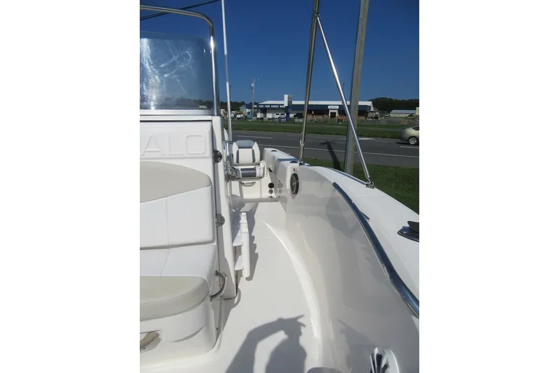 Slide: The Image of 2015 Robalo R180 Center Console boat, white interior, sunny day, roadside view. - 13