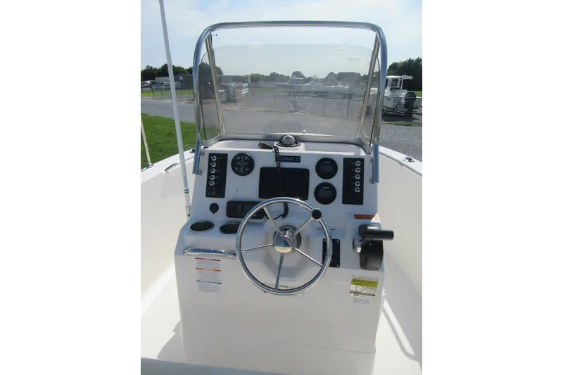 Slide: The Image of 2015 Robalo R180 Center Console boat dashboard with steering wheel and controls. - 15