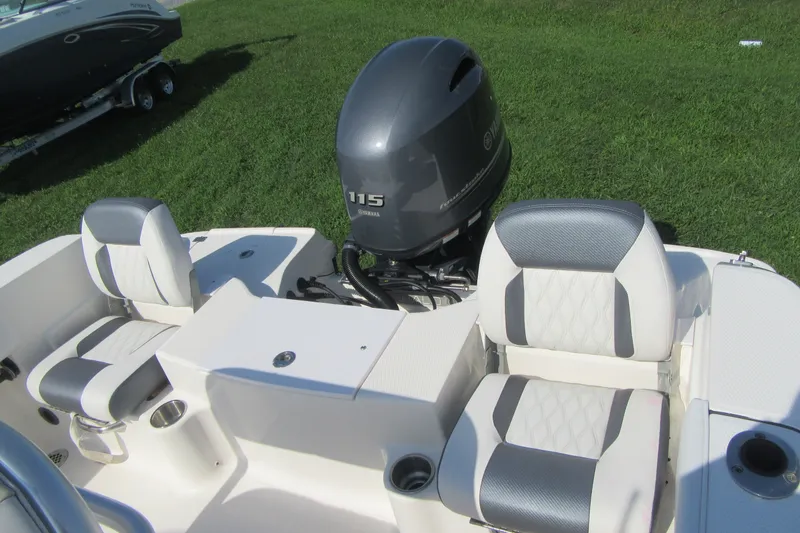 Slide: The Image of 2015 Robalo R180 Center Console boat with Yamaha 115 engine, featuring cushioned seating. - 20