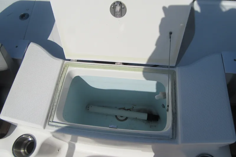 Slide: The Image of Open storage compartment on 2015 Robalo R180 Center Console boat. - 22
