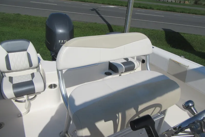 Slide: The Image of 2015 Robalo R180 Center Console boat interior with seating and motor. - 17