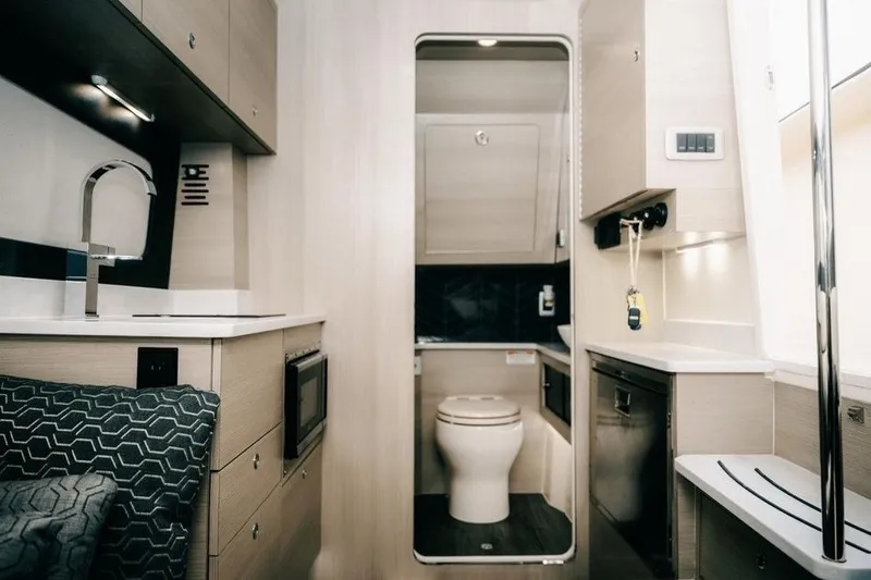 Slide: The Image of Luxurious interior of 2022 Scout 425 LXF boat featuring modern kitchen and bathroom. - 30
