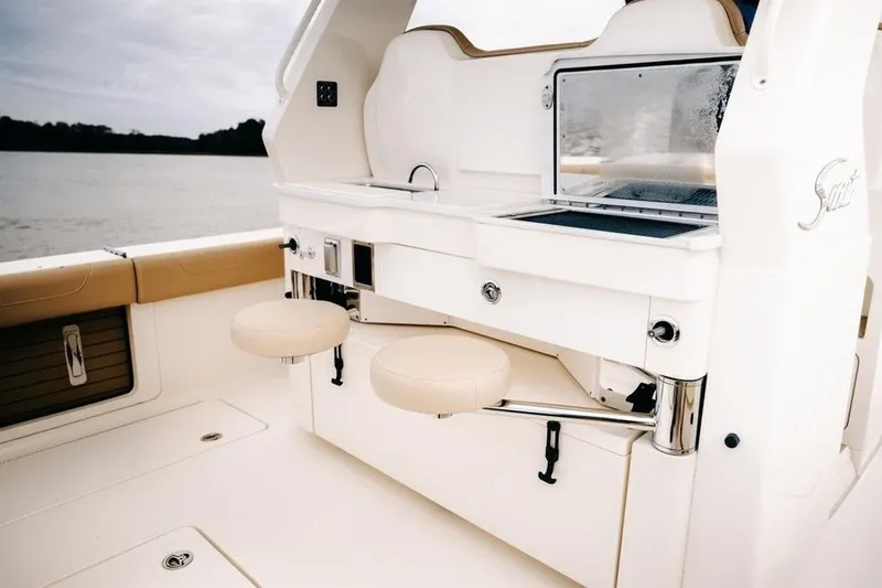 Slide: The Image of Luxury interior of 2022 Scout 425 LXF boat with seating and amenities. - 10