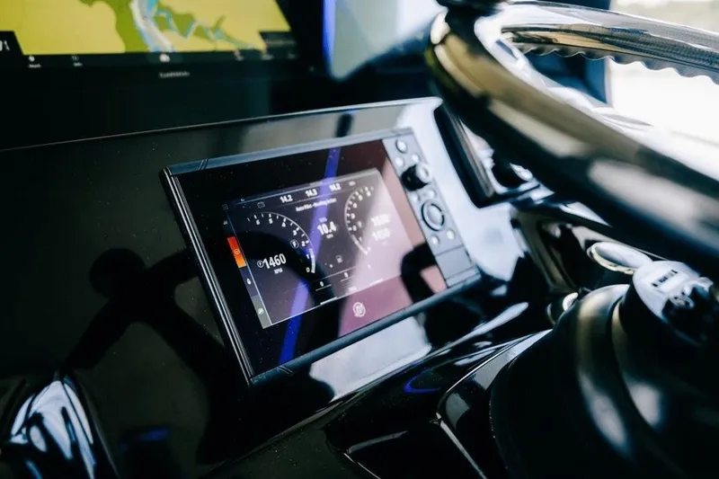 Slide: The Image of Dashboard of 2022 Scout 425 LXF boat with digital display and steering wheel. - 25