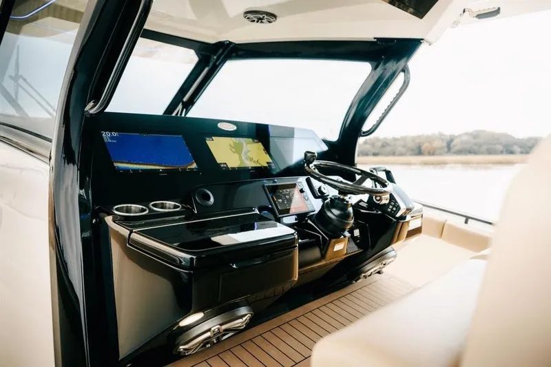Slide: The Image of Helm of 2022 Scout 425 LXF boat with modern navigation displays and controls. - 5