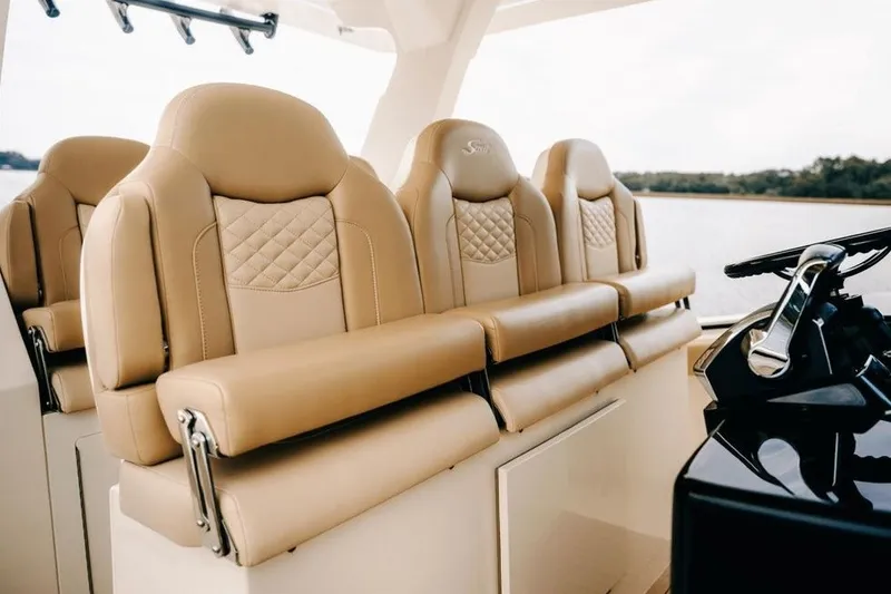 Slide: The Image of Luxurious seating on 2022 Scout 425 LXF boat, featuring elegant tan upholstery and modern design. - 34