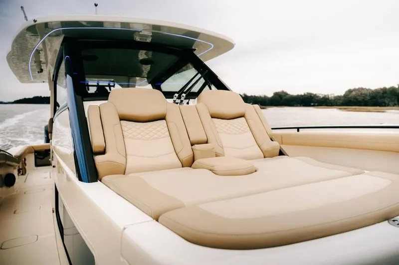 Slide: The Image of Luxurious seating on 2022 Scout 425 LXF boat, featuring elegant beige upholstery. - 18