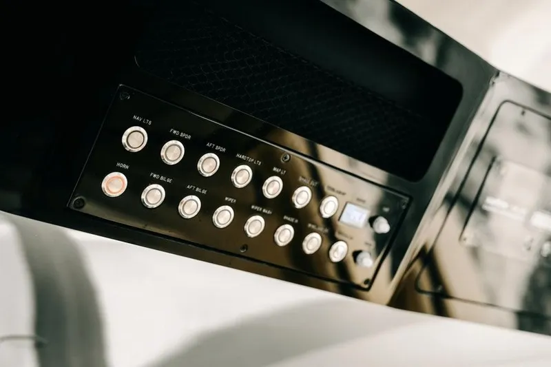Slide: The Image of Control panel of 2022 Scout 425 LXF boat with various buttons and switches. - 21