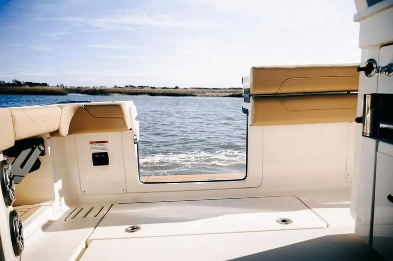 Slide: The Image of 2022 Scout 425 LXF boat interior with open deck view of water. - 13