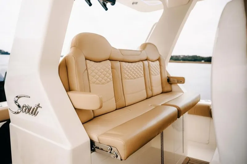 Slide: The Image of Luxurious seating on 2022 Scout 425 LXF boat, featuring tan leather upholstery and elegant design. - 17