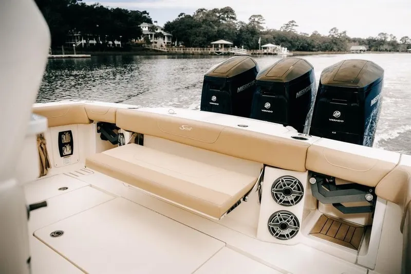 Slide: The Image of 2022 Scout 425 LXF boat with triple Mercury Verado engines, beige seating, and speakers. - 7