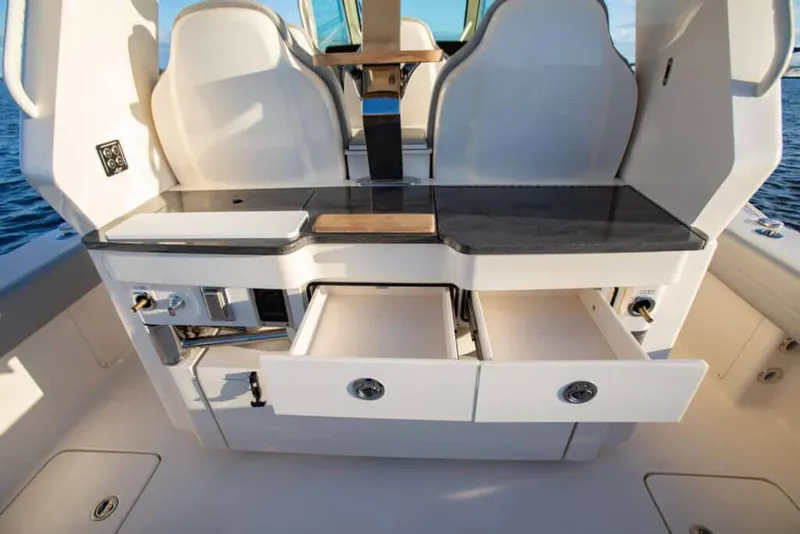 Slide: The Image of Manufacturer Provided Image: 2022 Scout 425 LXF boat interior with open storage drawers and seating. - 11