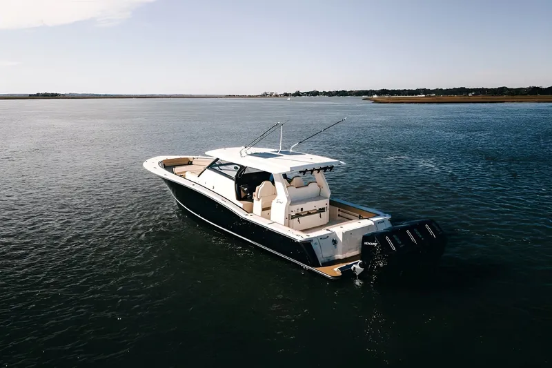 Slide: The Image of 2022 Scout 425 LXF boat cruising on open water, showcasing luxury design and powerful engines. - 1