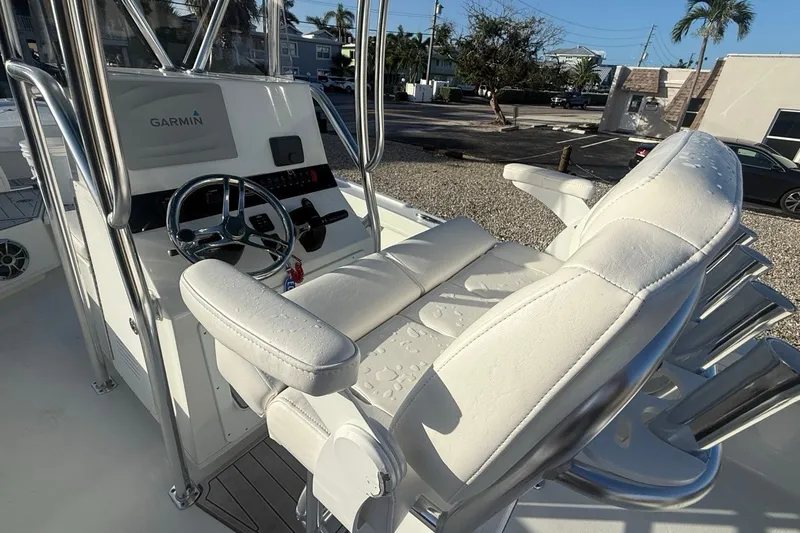 Slide: The Image of 2021 Pair Customs 21 Center Console MV boat interior with Garmin navigation system and white seating. - 14