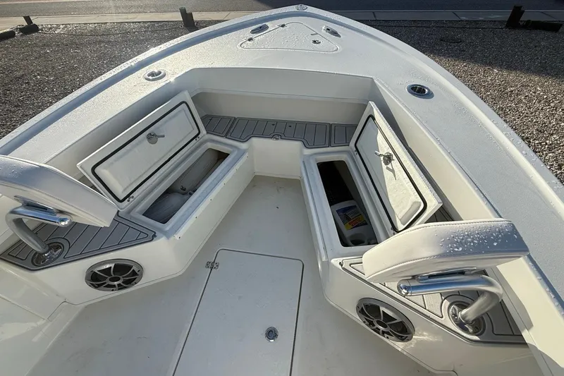 Slide: The Image of 2021 Pair Customs 21 Center Console MV boat interior with open storage compartments. - 26