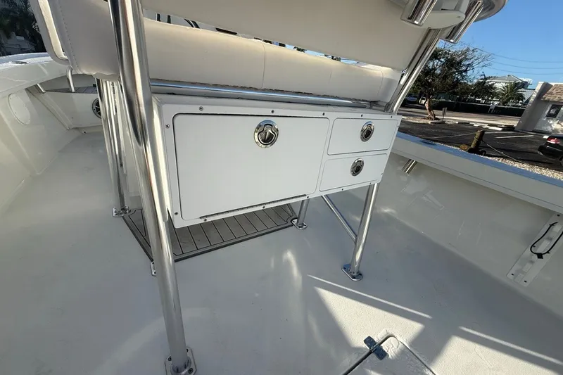 Slide: The Image of 2021 Pair Customs 21 Center Console MV boat interior with storage compartments and stainless steel fixtures. - 19
