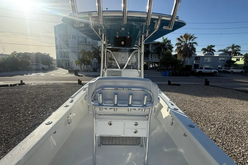 Slide: The Image of 2021 Pair Customs 21 Center Console MV boat with T-top and seating, parked outdoors. - 18