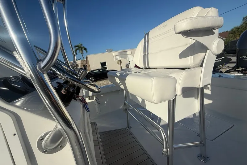 Slide: The Image of 2021 Pair Customs 21 Center Console MV boat interior with white seating and chrome details. - 16