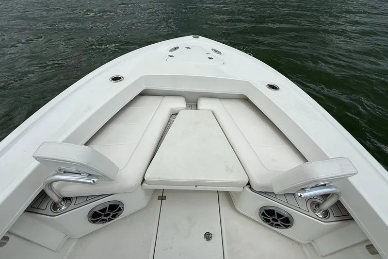 Slide: The Image of 2021 Pair Customs 21 Center Console MV boat interior with white seating and speakers. - 24
