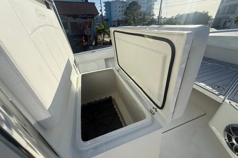 Slide: The Image of Open storage compartment on 2021 Pair Customs 21 Center Console MV boat. - 23