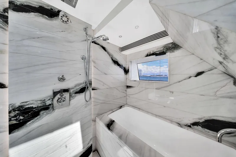 Slide: The Image of Luxurious marble bathroom interior on 2021 Sirena 88 yacht, featuring modern shower and bathtub. - 87