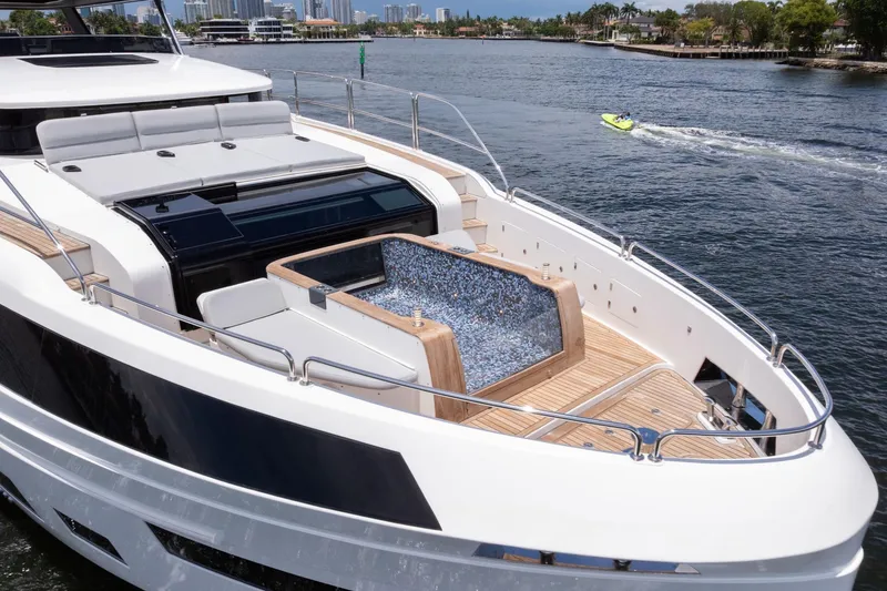 Slide: The Image of Luxury Sirena 88 yacht with sleek design and spacious deck, cruising on a sunny day. - 33