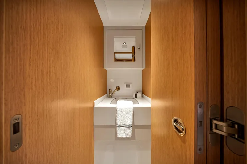 Slide: The Image of Luxurious bathroom interior on 2021 Sirena 88 yacht, featuring sleek wood paneling and modern fixtures. - 137