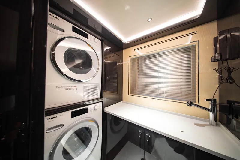 Slide: The Image of Laundry room in 2021 Sirena 88 yacht with stacked Miele washer and dryer. - 98