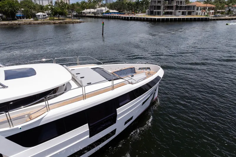 Slide: The Image of Luxury Sirena 88 yacht cruising on water, 2021 model, near waterfront homes. - 31