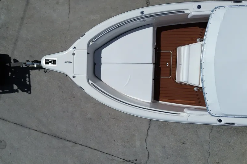 Slide: The Image of Aerial view of a white boat with a brown deck, positioned on a trailer. - 16