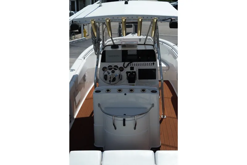 Slide: The Image of The image shows the cockpit of a 2005 Triton 2690 CC boat with modern electronics. - 13