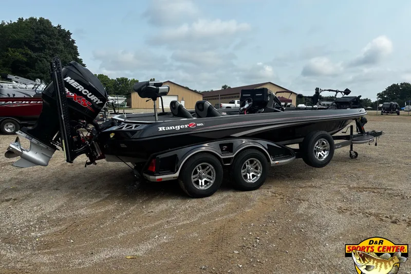 Slide: The Image of 2018 Ranger Z520L boat with Mercury engine on a trailer in a parking lot. - 2