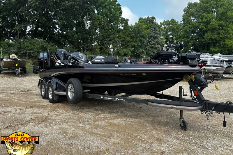 Slide: The Image of 2018 Ranger Z520L boat on trailer at D&R Sports Center, surrounded by trees. - 1