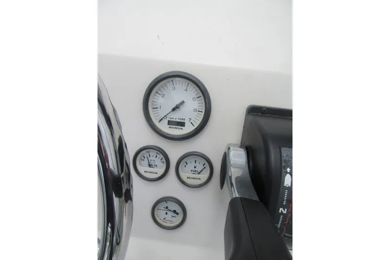 Slide: The Image of Dashboard of a 2015 Allied 17 Sportsman boat with Honda gauges and controls. - 15