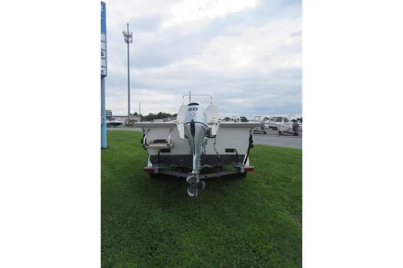 Slide: The Image of 2015 Allied 17 Sportsman boat on trailer, rear view, parked on grass under cloudy sky. - 5