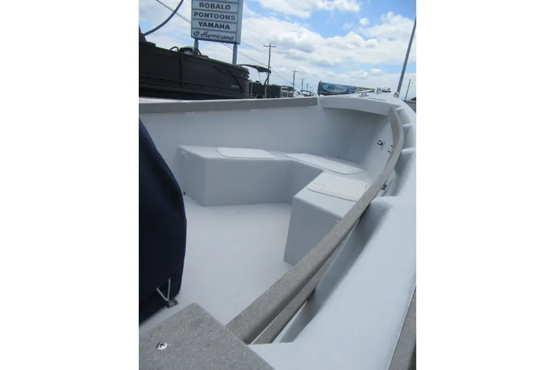 Slide: The Image of 2015 Allied 17 Sportsman boat interior with seating, under a partly cloudy sky. - 7